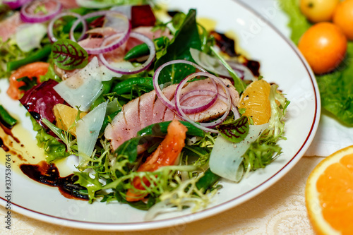 salad with smoked meat and ingredients served on the table