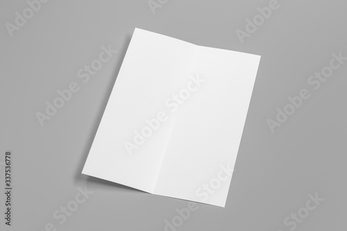 Blank vertical A4 leaflet on gray background. Bi-fold or half-fold opened brochure isolated with clipping path. Side view. 3d illustration