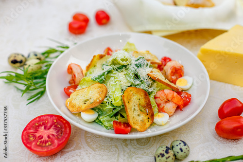 Caesar salad with seafood vegetables and herbs, healthy food on the table