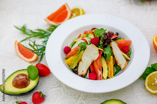 salad with chicken vegetables and herbs, healthy food on the table