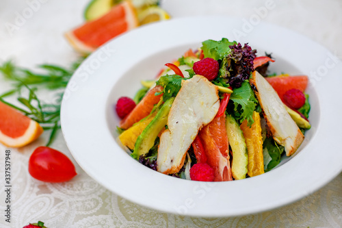 salad with chicken vegetables and herbs, healthy food on the table