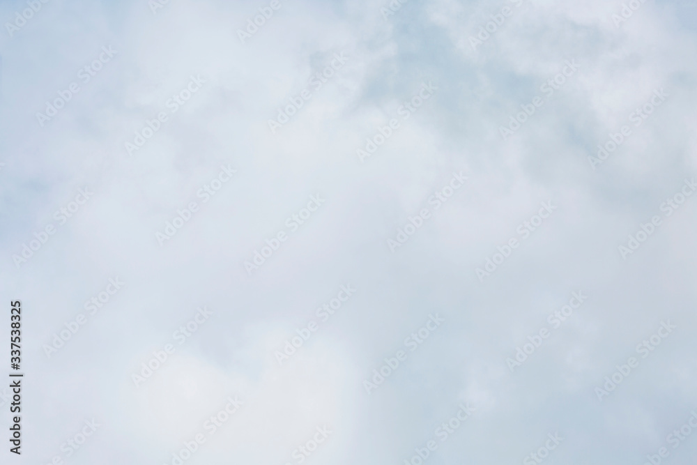 Dense cumulus clouds on a clear blue sky. Space for text. Background.