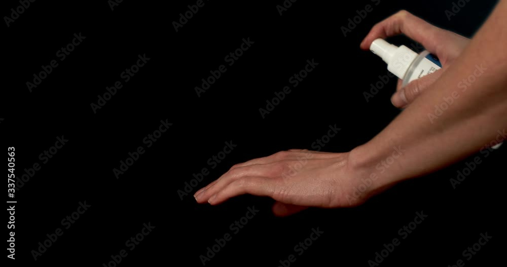 Closeup of woman's hands using an alcohol based hand sanitizer. Cinematic 4K footage.