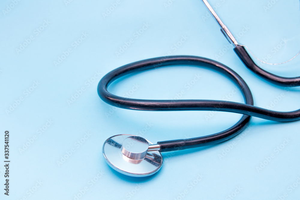 Black Stethoscope isolated on blue background, top view. Medical tool Black Stethoscope isolated on blue background, top view. Medical tool