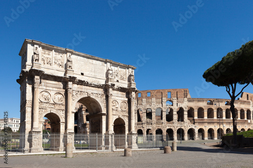 The Arch of Constantine (Arco di Costantino). .Triumphal arch and Colosseum on background. Rome, Italy photo
