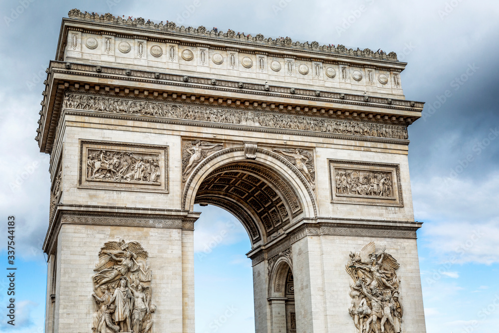 Arc de Triomphe in Paris against the backdrop of a beautiful bright blue sky. Close-up.
