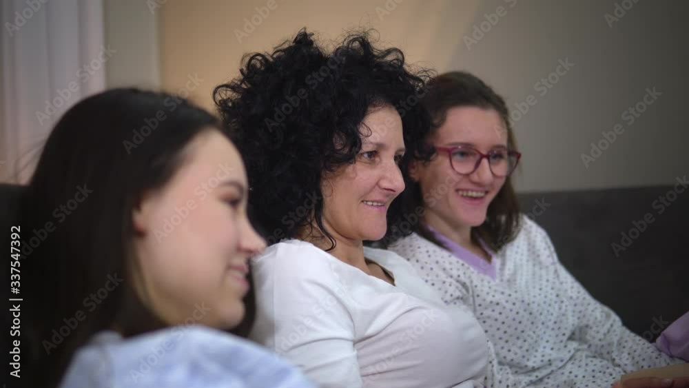 Happy smiling family in pyjamas enjoy home quarantine after found positive to corona virus pandemic desease Happy smiling family in pyjamas enjoy home quarantine after found positive to corona virus pandemic desease