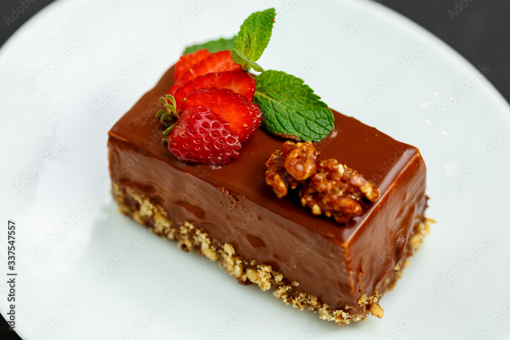 a slice of delicious chocolate cake with nuts and berries a slice of delicious chocolate cake with nuts and berries