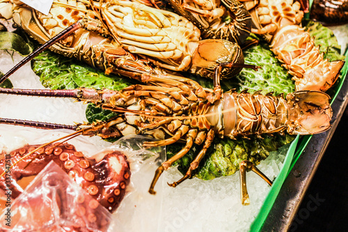 Close-up of lobster and a large octopus on ice on market counter in Barcelona