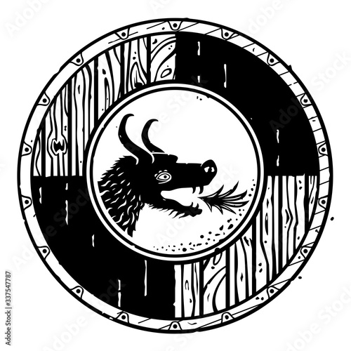 Vintage style vector fantasy drawing of a round wooden shield with a dragon head. can represent the Middle Ages, the Vikings, a medieval adventure, an emblem, gear for a quest or a Norse warrior.