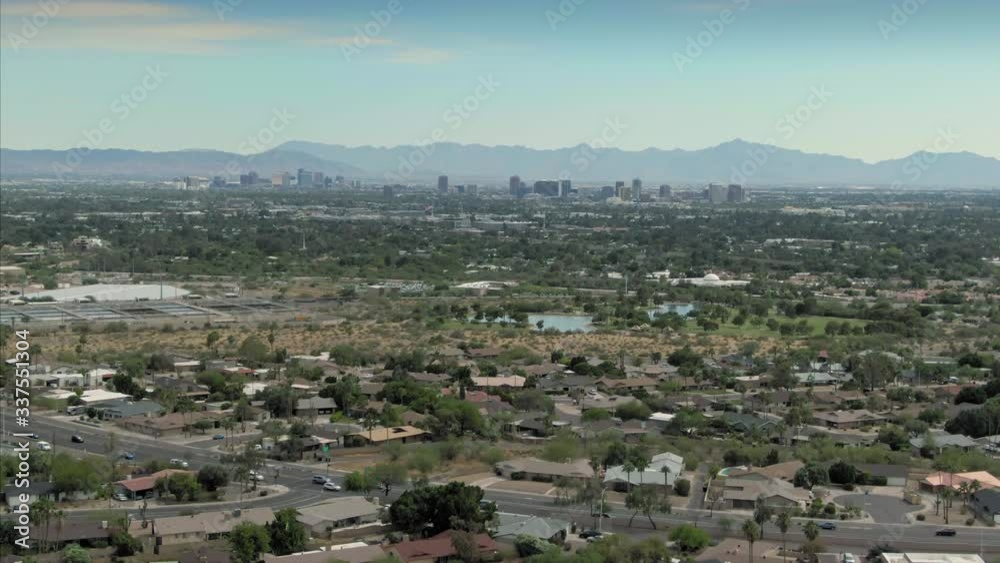 Aerial flying over suburbs with downtown Phoenix in the distance. Arizona, USA. Aerial flying over suburbs with downtown Phoenix in the distance. Arizona, USA.