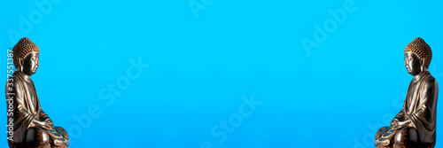 Fotografie Replica statues of The Buddha with a blue background, blue symbolizing immortality and advancement