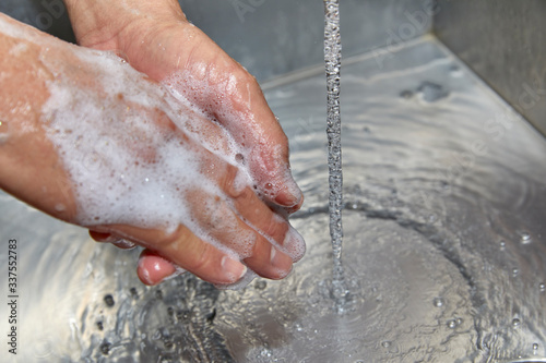 A Man's Hands with Soap and Water on Them