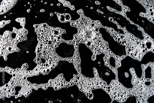 White foam bubbles on a black background