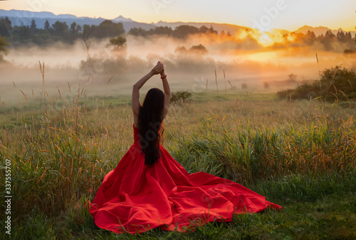 woman in red dress on the sunrise