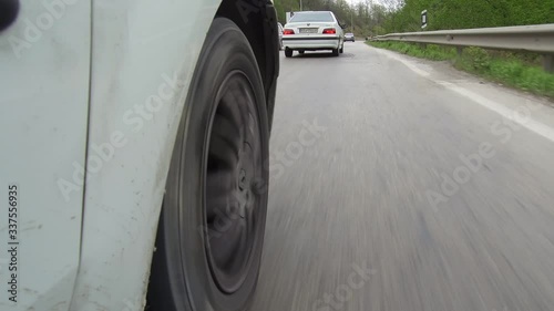 CHALUS, IRAN: Dolly Tracking low angel car driving wheel rolling pov close up in a road mounted camera photo