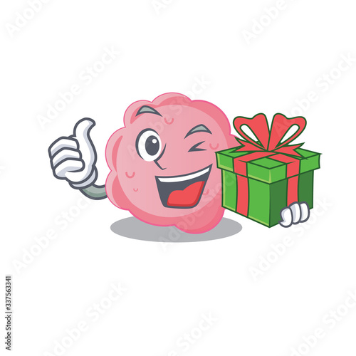 Smiling anaplasma phagocytophilum cartoon character having a green gift box photo