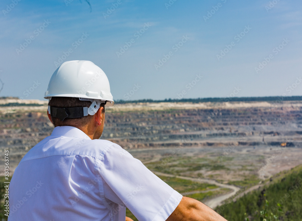 A mining engineer inspects huge granite quarries in Mikashevichy, Belarus. One of the largest quarries in the world, measuring 2 by 3 kilometers and a depth of 500 meters A mining engineer inspects huge granite quarries in Mikashevichy, Belarus. One of the largest quarries in the world, measuring 2 by 3 kilometers and a depth of 500 meters
