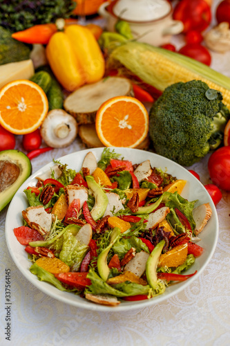 salad with smoked chicken and vegetables on the decorated table