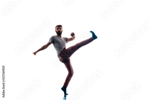 Young dancer posing over white wall