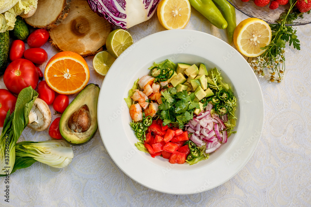 Salad with shrimps and vegetables, healthy food on the decorated table Salad with shrimps and vegetables, healthy food on the decorated table