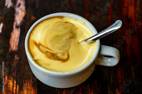 Konstfotografi Top view a cup of Giang egg coffee  on wood background