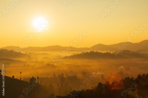 The morning sun and the orange sky are above the mountains. © WORANAN-TH