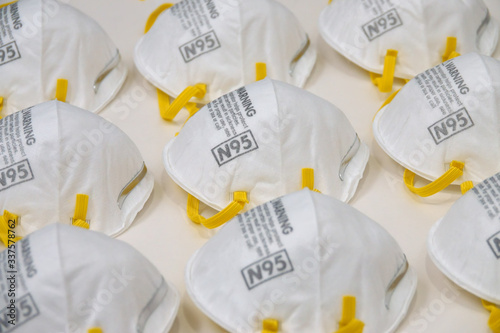 Tableau sur toile A stockpile of generic, new N95 respirator dust masks is shown in a closeup view from the side