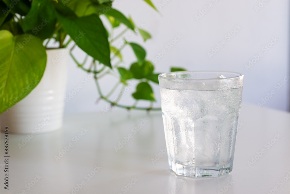 a glass of iced water on white table a glass of iced water on white table