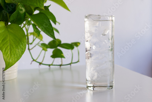 a glass of iced water on white table 