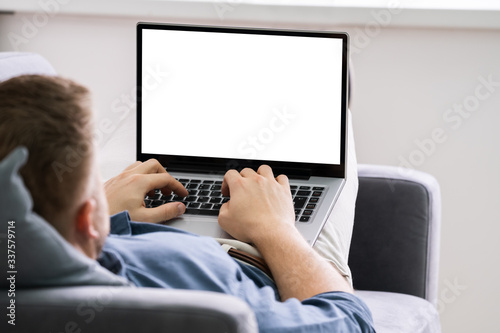 Young Man Using Laptop At Home