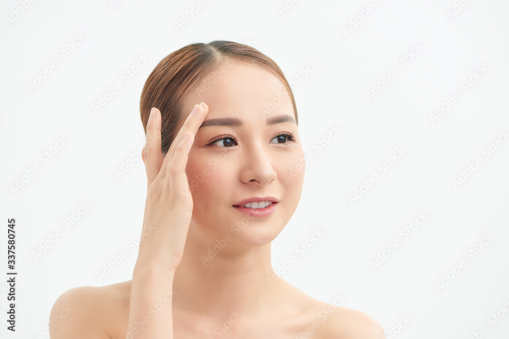 Attractive young Asian girl touching her face on white background. Beauty & Skin care concept Attractive young Asian girl touching her face on white background. Beauty & Skin care concept