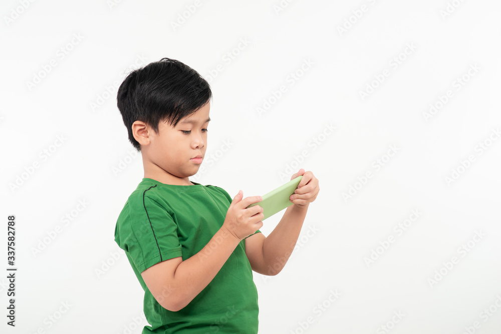 Gambling addiction. Focused teenage boy playing video games on cell phone, white studio background Gambling addiction. Focused teenage boy playing video games on cell phone, white studio background