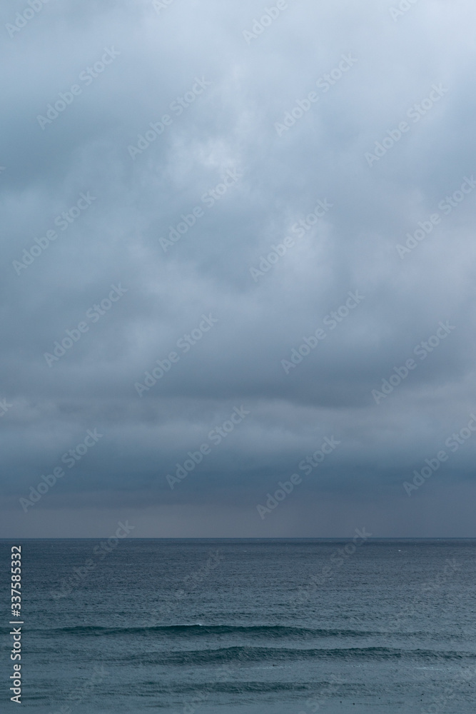View of sea against cloudy sky during rain