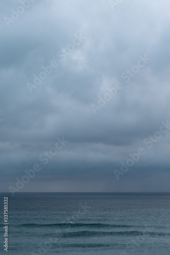 View of sea against cloudy sky during rain