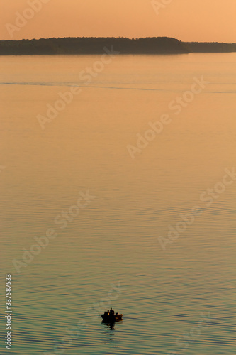 fishing boat on the lake at sunset