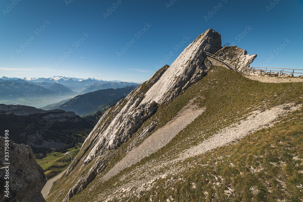Obraz premium Scenic view of steep rocky mountains and grassy slopes high up in the alps on Mount Pilatus in Lucerne, Switzerland
