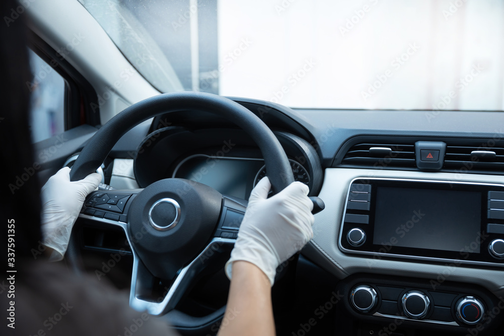 person with gloved hands inside car due to coronavirus pandemic in mexico, covid19
