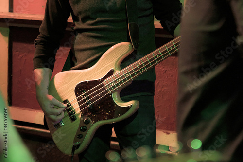 Rock musician at a concert in a small venue, playing the bass, New York City, NY