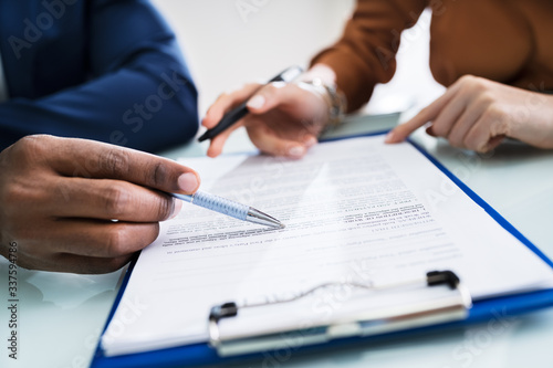 Two Businesspeople Analyzing Document