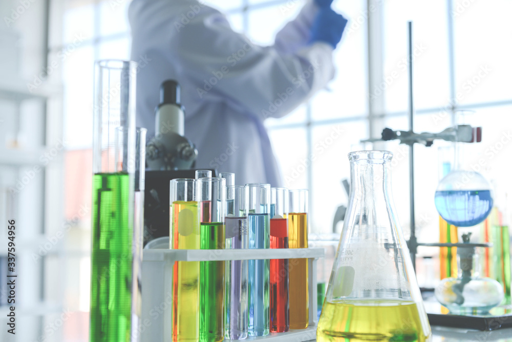 Close up of glass laboratory chemical with chemical compounds inside in the lap and test by medical research scientist