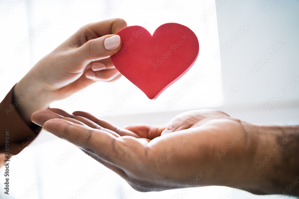 Woman Giving Heart On Man's Hand Woman Giving Heart On Man's Hand
