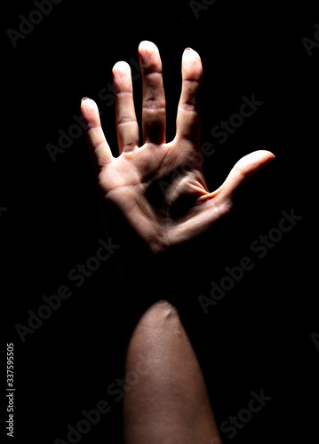 Palm of a girl's hand on a black background