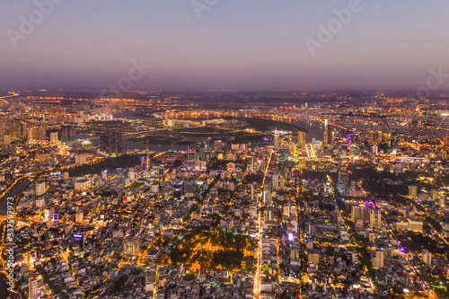 Top view aerial photo from flying drone of a Ho Chi Minh City with development buildings, transportation, energy power infrastructure. Financial and business centers in developed Vietnam. © Hien Phung