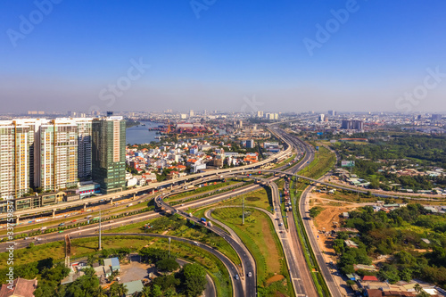 Top view aerial of Cat Lai crossroads, Ho Chi Minh City with development buildings, transportation, infrastructure, Vietnam. 