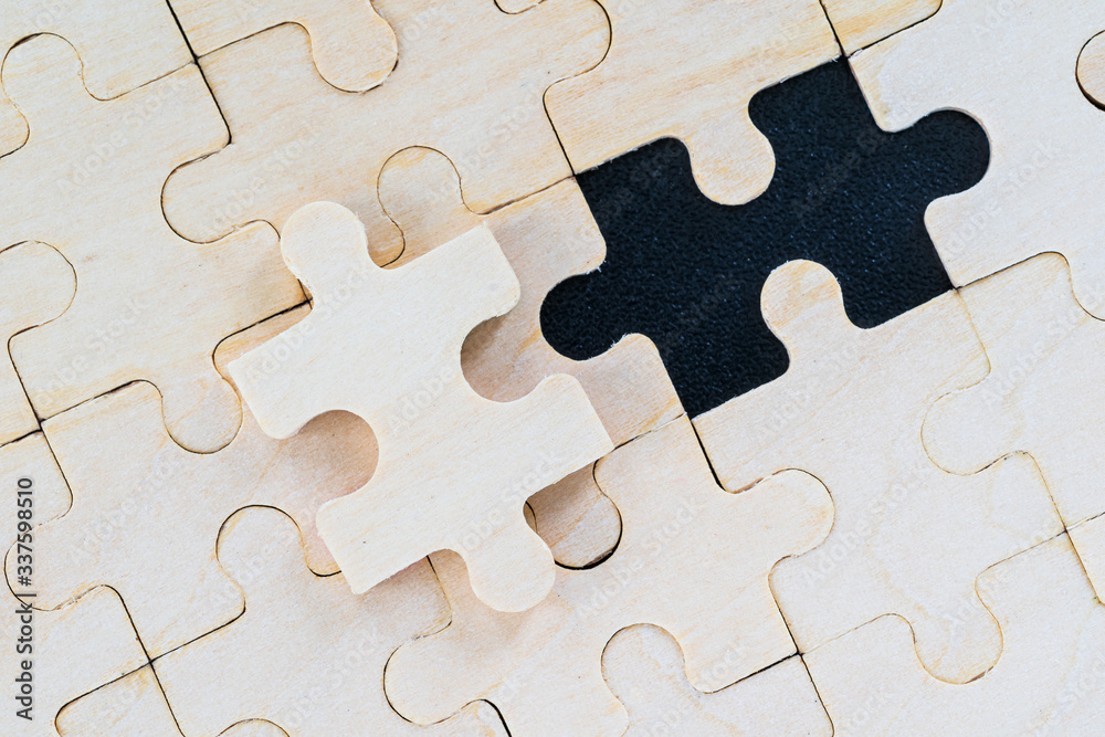 wooden jigsaw puzzle pieces on black background wooden jigsaw puzzle pieces on black background