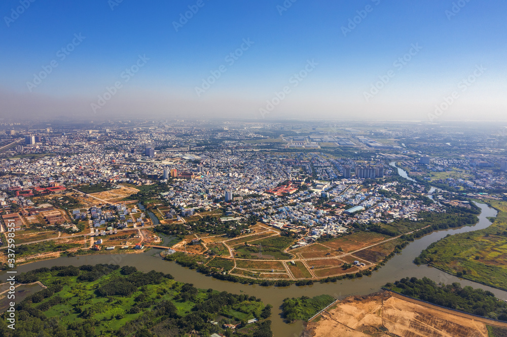 Top view aerial of Rach Chiec residential area, Ho Chi Minh City with development buildings, transportation, energy power infrastructure. Financial and business centers in developed Vietnam. Top view aerial of Rach Chiec residential area, Ho Chi Minh City with development buildings, transportation, energy power infrastructure. Financial and business centers in developed Vietnam.