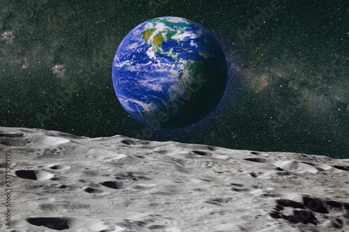 Moon limb with Earth rising on the horizon.Earth rises above lunar horizon. Elements of this image furnished by NASA.