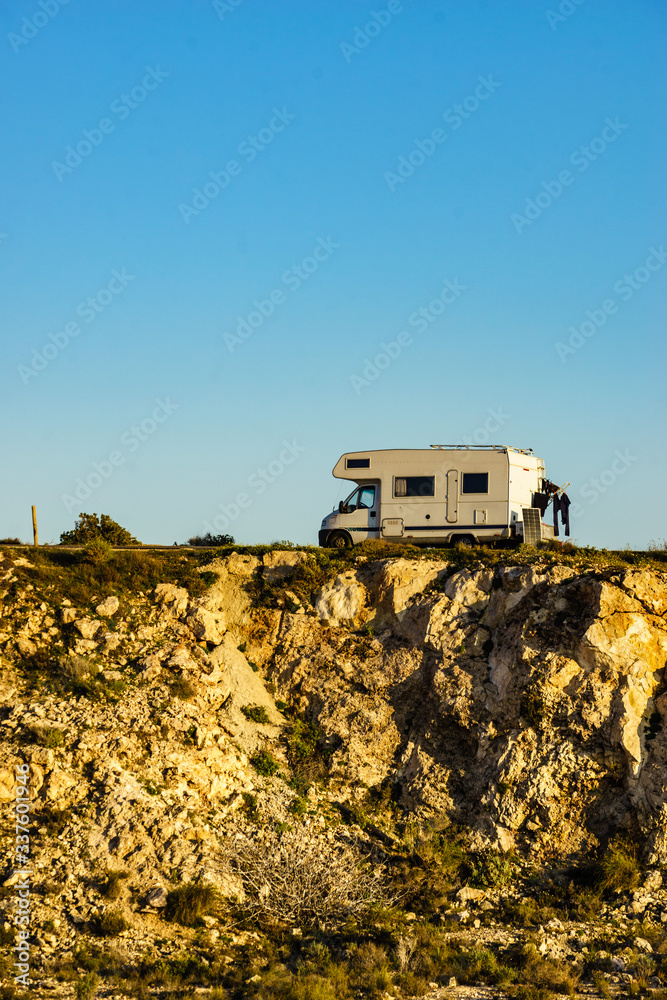 Fototapeta premium Camper camping on cliff rock, Spain