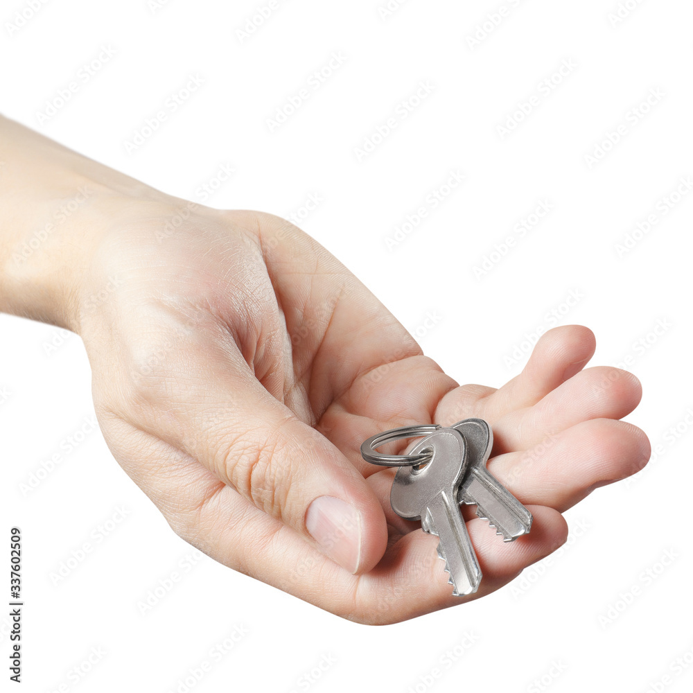 Male hand offering house keys, isolated on white background Male hand offering house keys, isolated on white background